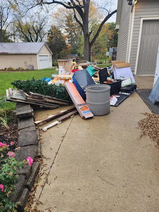 Dumpster being loaded with debris for 12 Yard Dumpster Rental in Lockport